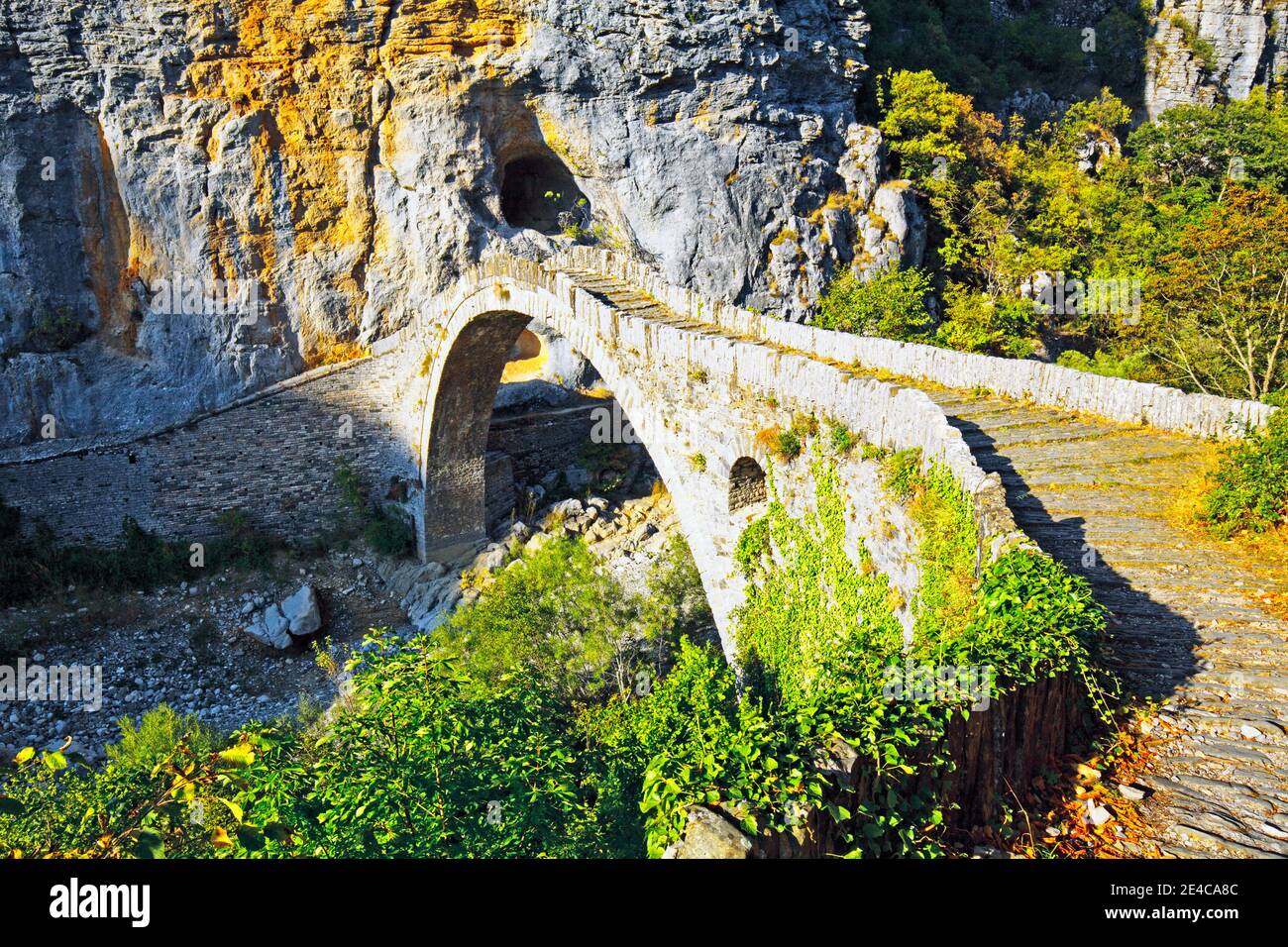 The single-arch Kokkoris stone bridge was built in 1750, it spans a narrow brook valley between two steep walls, mountainous region of Epirus, northern Greece Stock Photo
