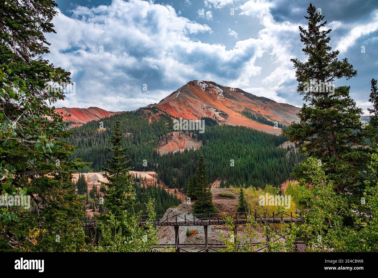 The colors of Red Mountain Colorado stand out against a stormy sky along route 550 Stock Photo