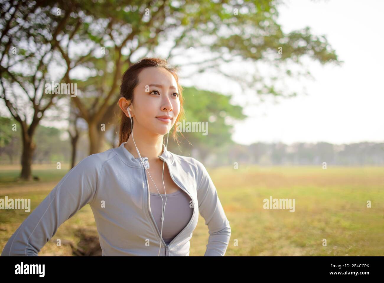 closeup beautiful young woman face before running in the park at  morning Stock Photo