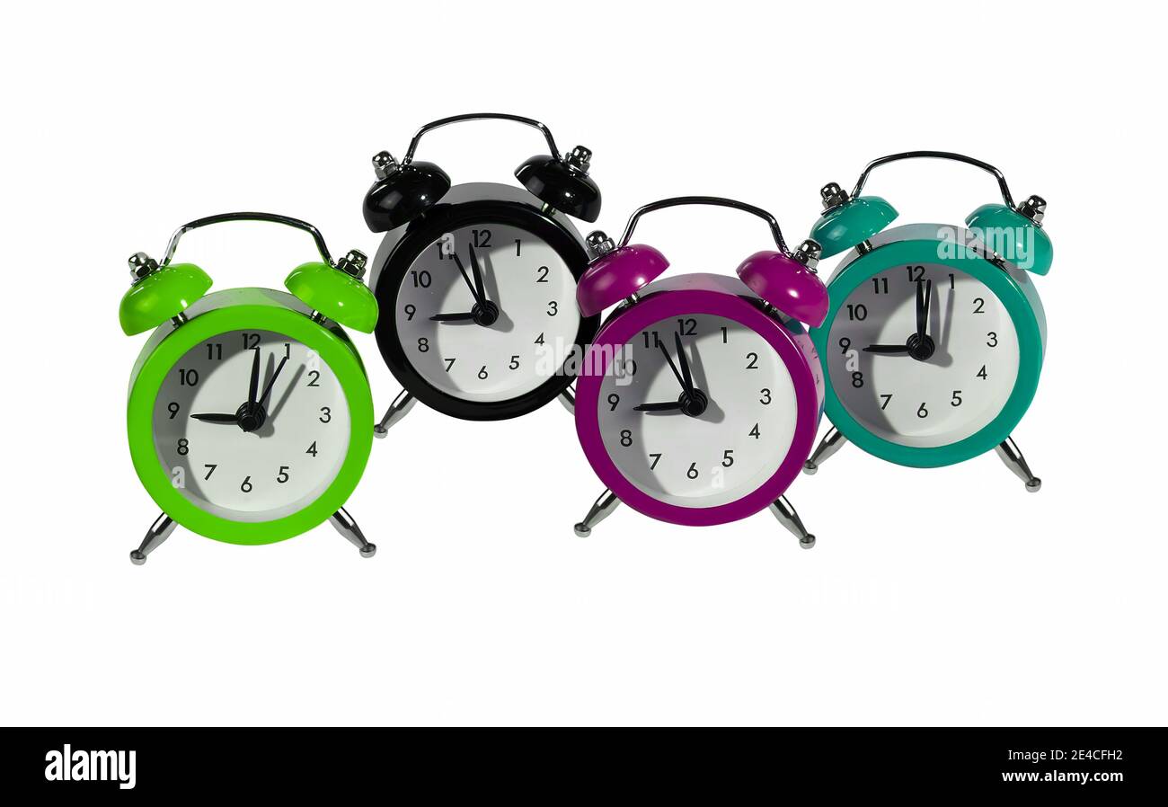 Four retro alarm clocks in vibrant colors Stock Photo Alamy