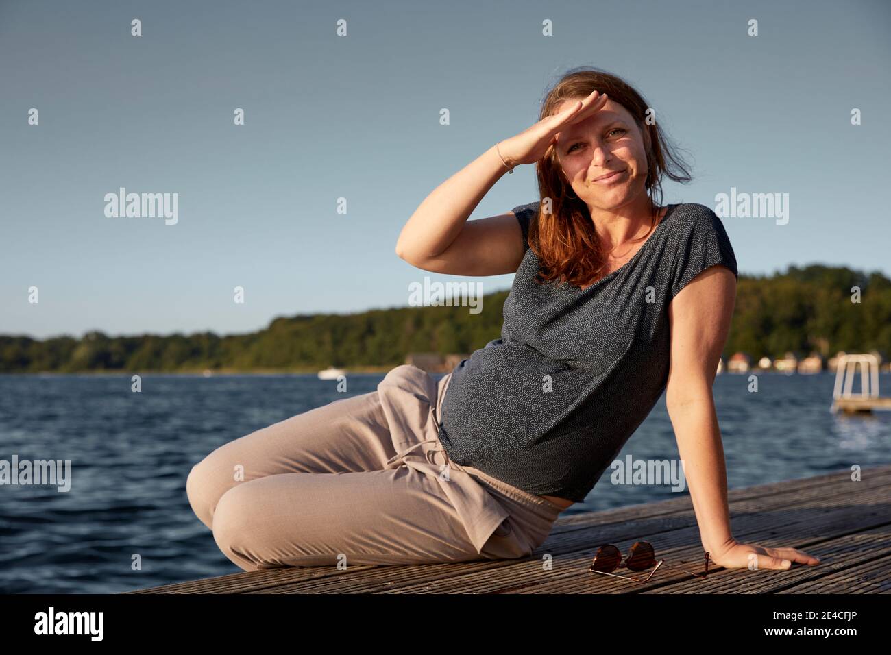 pregnant woman, landing stage, direct view Stock Photo