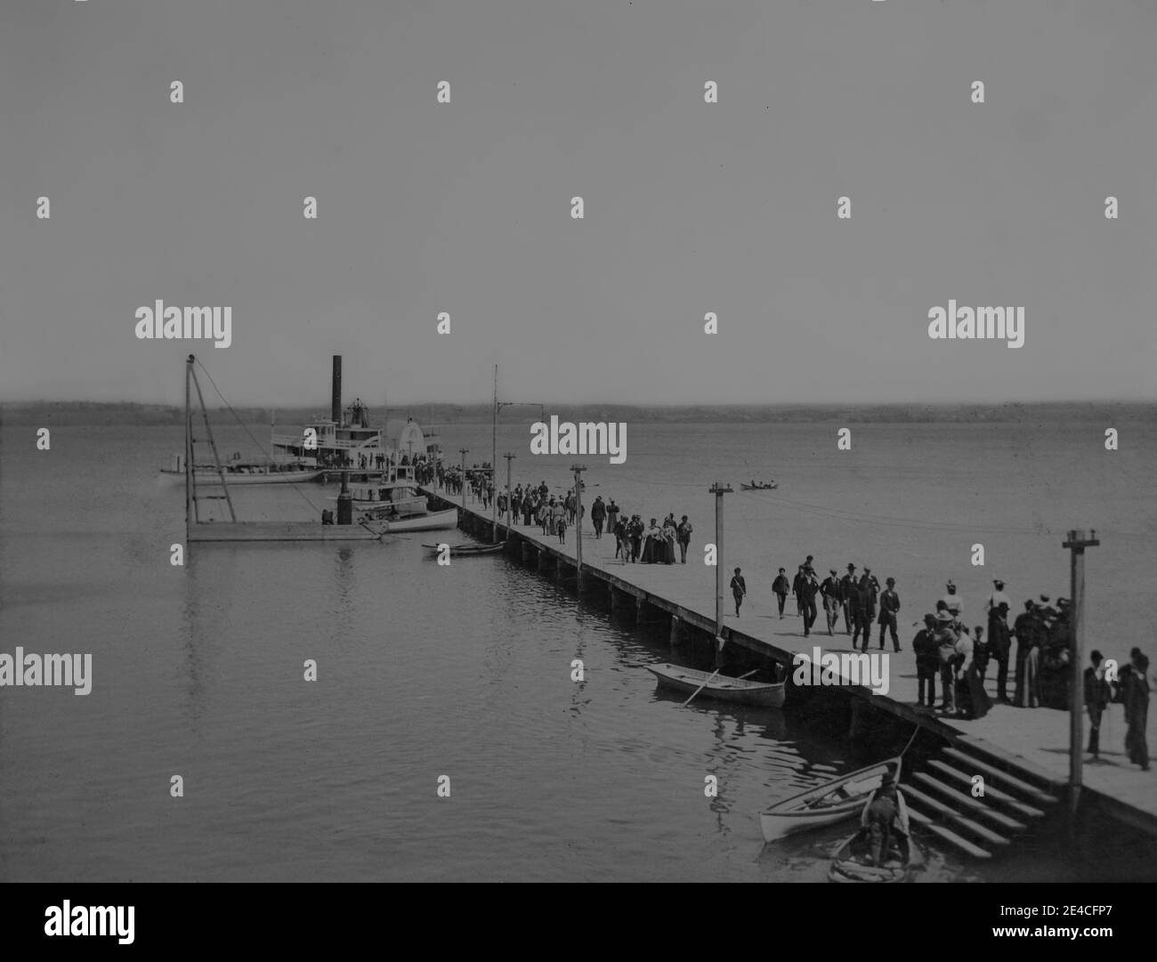 American archive monochrome photo of a paddle steamer on Lake Cayuga at end of a pier unloading passengers, dated May 30th 1896. Taken in the late 19th century in NY, USA Stock Photo