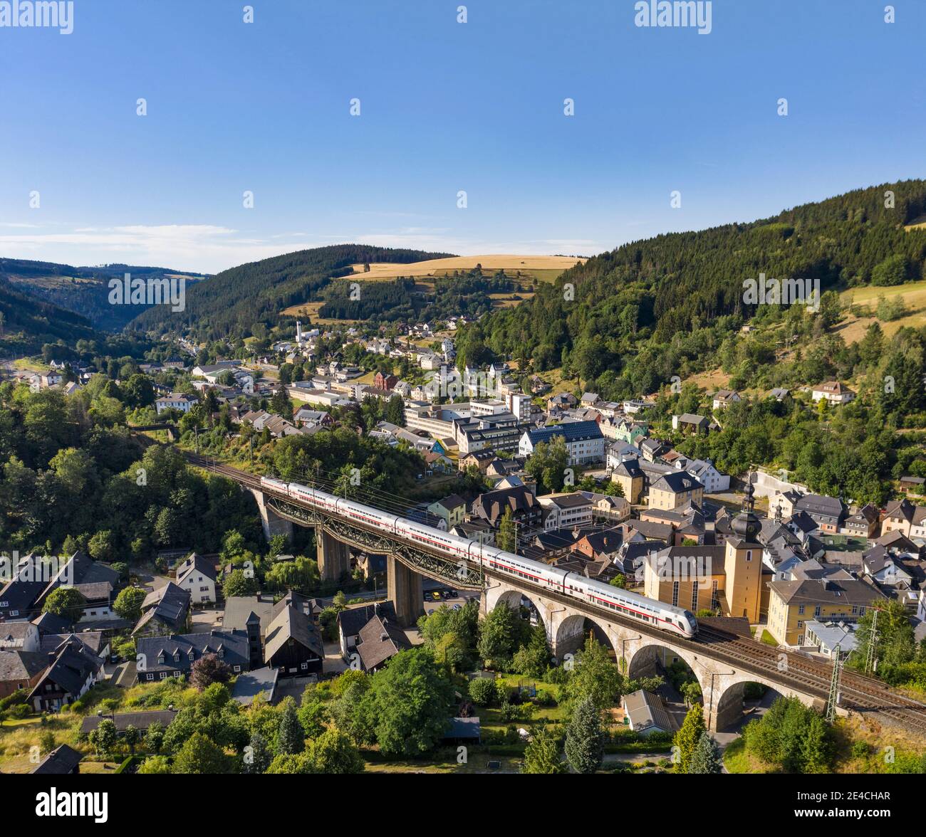 Germany, Bavaria, Ludwigsstadt, train, intercity, bridge, city, church, houses, aerial view Stock Photo