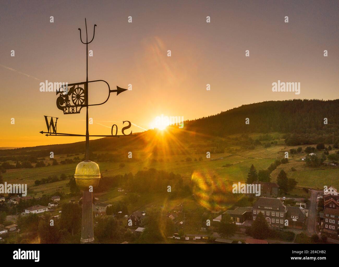 Germany, Thuringia, Ilmenau, Möhrenbach, weather vane, steeple, sunrise, back light Stock Photo