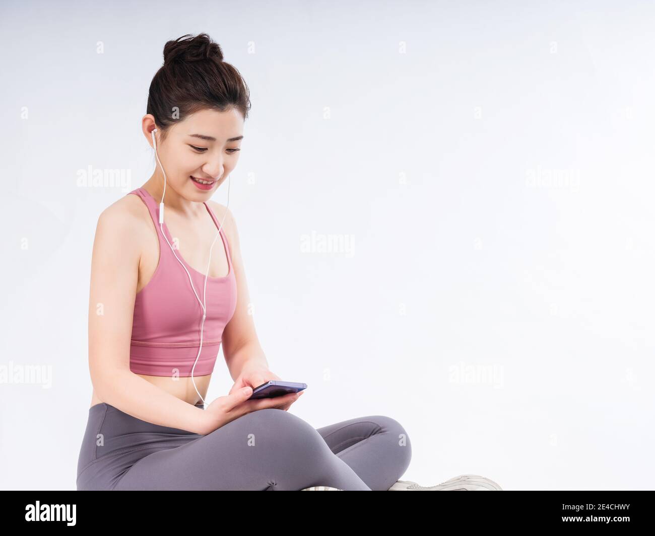 Young women in sports vests relax by listening music Stock Photo