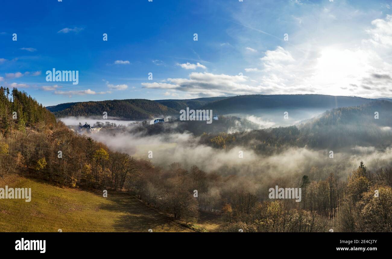 Germany, Thuringia, Schwarzburg, landscape, castle ruins, former baroque castle, forest, fields, mountains, valleys, valley fog, aerial view, back light Stock Photo