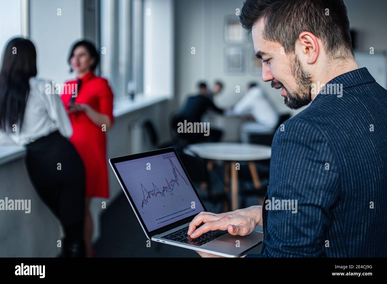 Shot of a young businessman leader working on a laptop in an office Stock Photo