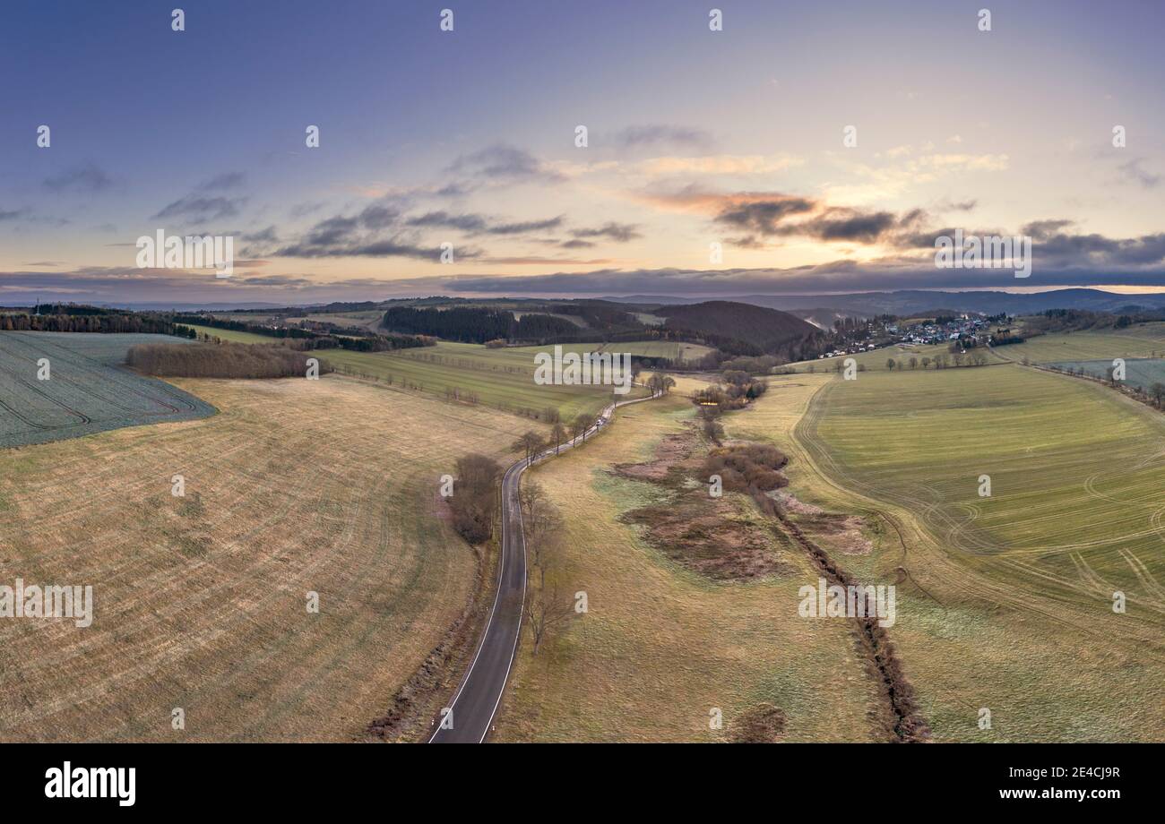 Germany, Thuringia, Großbreitenbach, Allersdorf, scenery, road, fields, village in the background, mountains, morning mood, aerial view Stock Photo