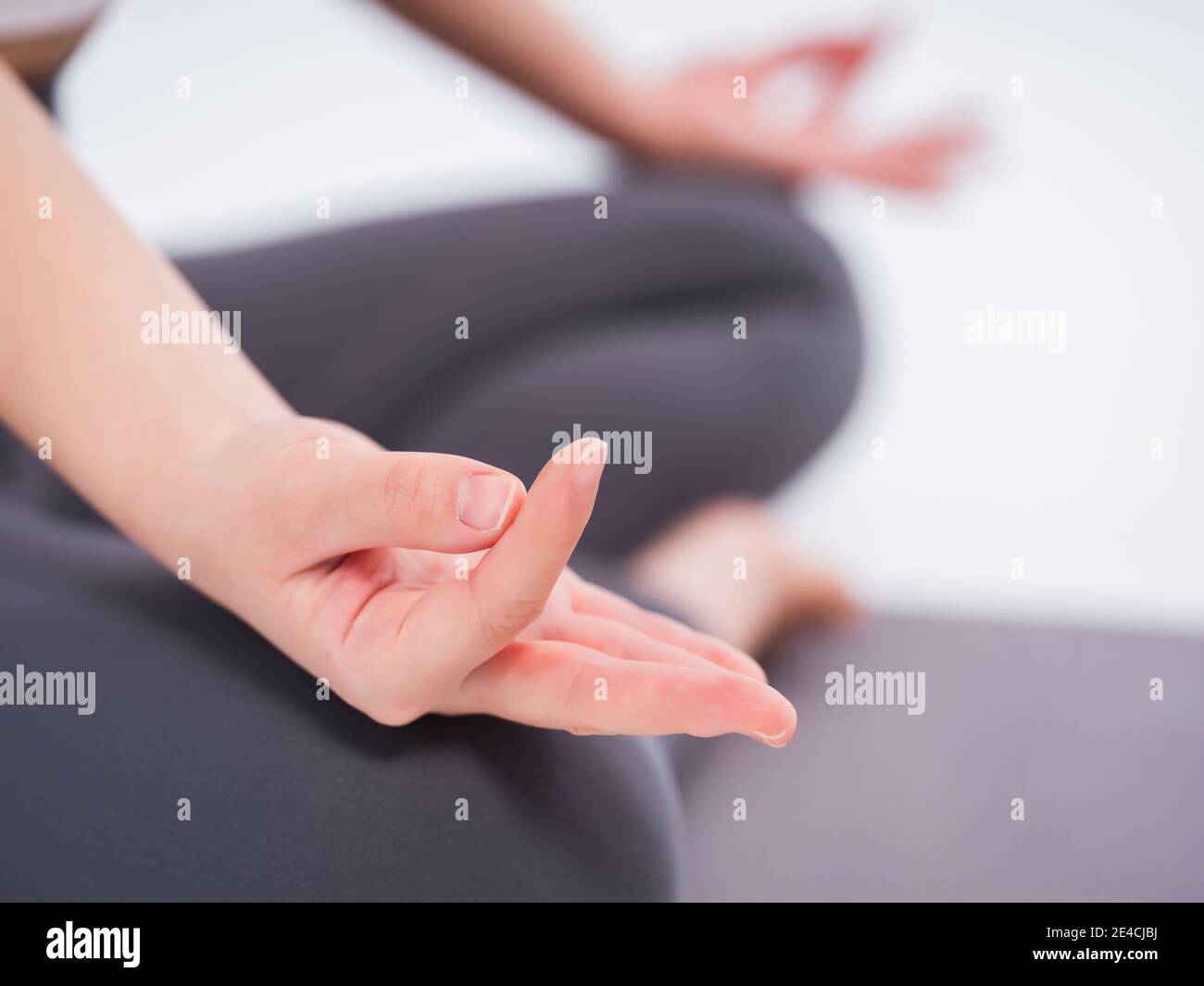 Young women practice yoga feature in hand Stock Photo