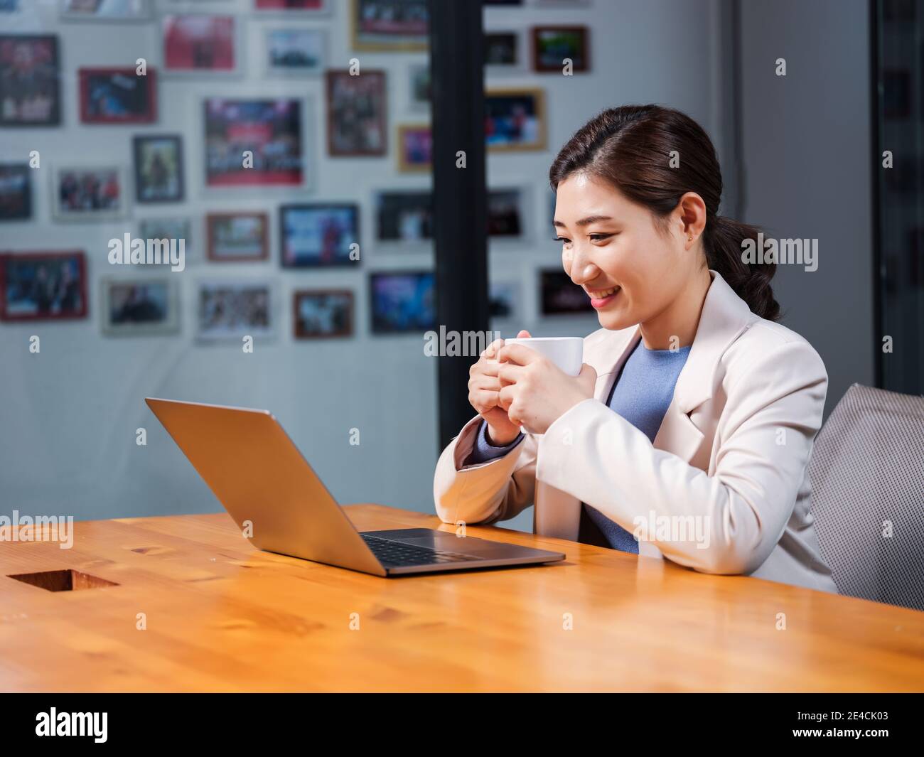 Business women use laptops with a cup of coffee Stock Photo