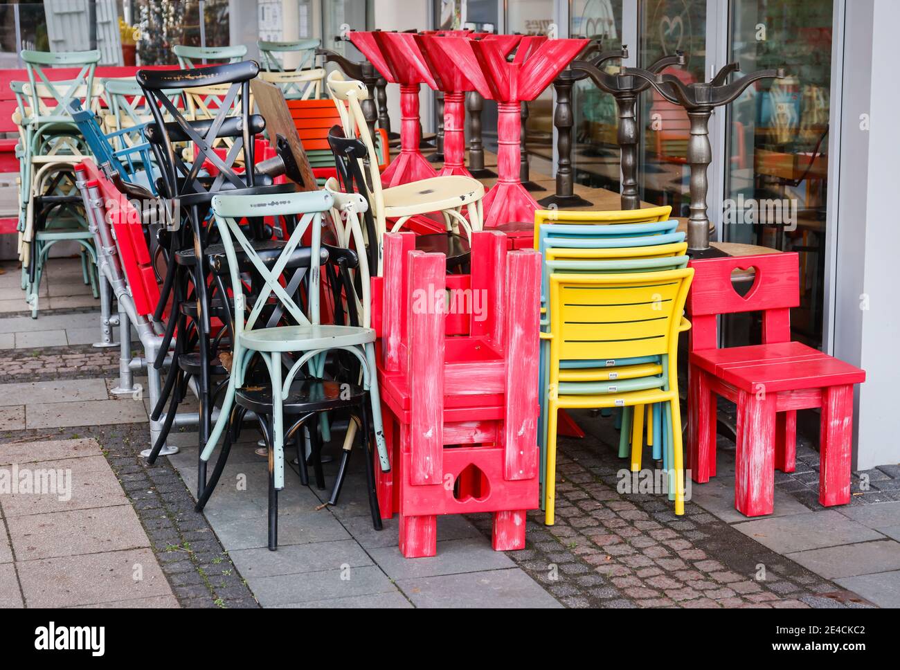 Essen, Ruhr area, North Rhine-Westphalia, Germany - Gastronomy in crisis, stacked tables and chairs in front of a closed restaurant in downtown Essen in times of the corona pandemic at Christmas time. Stock Photo