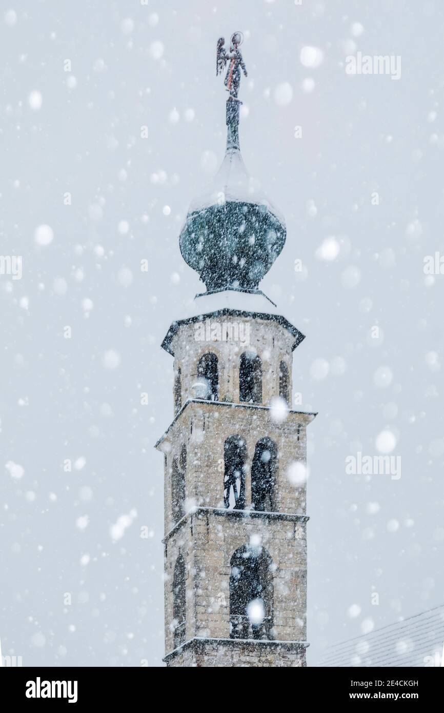Italy, Veneto, province of Belluno, Agordino, parish church of San Tomaso Agordino under a snowfall, Dolomites Stock Photo