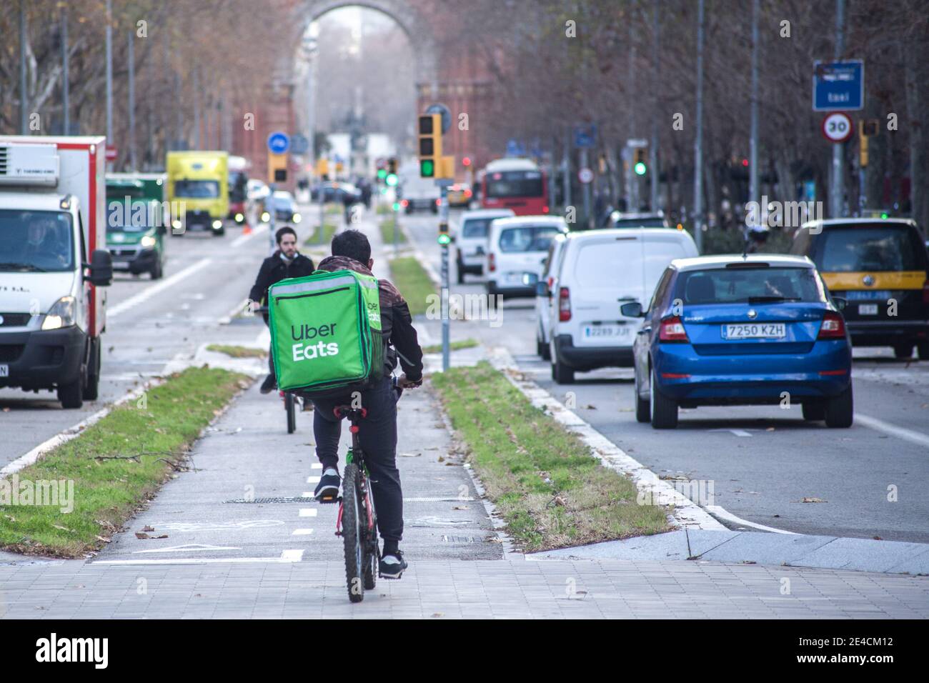 Barcelona, Spain. 22nd Jan, 2021. Uber Eats app delivery man seen riding a bike. The Ministry of Labor of Spain is developing a legislative framework that encompasses the activity of home delivery people known as riders, who operate for digital platforms such as Glovo, Deliveroo, Just Eat or Uber Eats. The new Rider Law would oblige companies to hire their workers and thus end the figure of the false self-employed. Credit: SOPA Images Limited/Alamy Live News Stock Photo