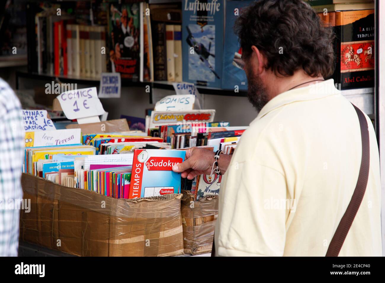 Coruna-Spain. Man catching a sudoku game in a second-hand book store during a specialized fair on August 19, 2019 Stock Photo