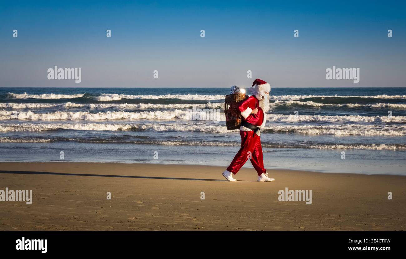 Running Santa Claus on Gruissan Beach Stock Photo