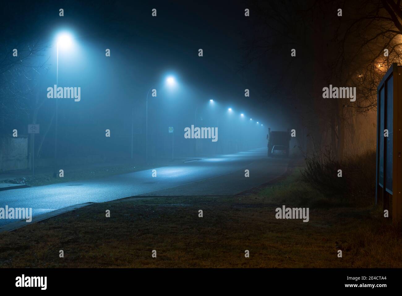 Fog in the streets of the town of Luckenwalde ,Road at night without people and cars Stock Photo
