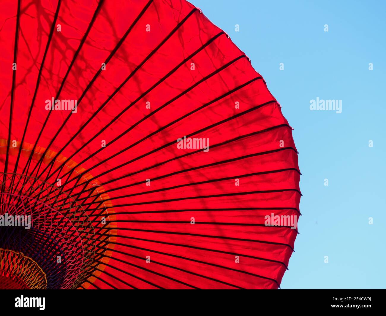 A red parasol against blue sky in Tokyo, Japan. Stock Photo
