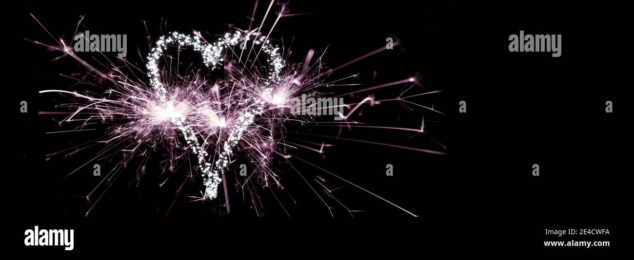 New Year 2021, sparklers and heart made of fairy lights Stock Photo