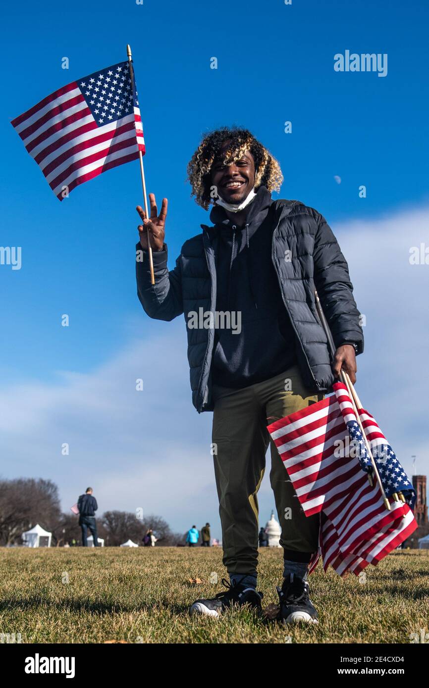 WASHINGTON D.C., JANUARY 21- "The Field of Flags" at the National Mall is  disassembled flag by flag the day after the Inauguration onJanuary 21, 2021  in Washington, DC Nearly 200,000 flags were
