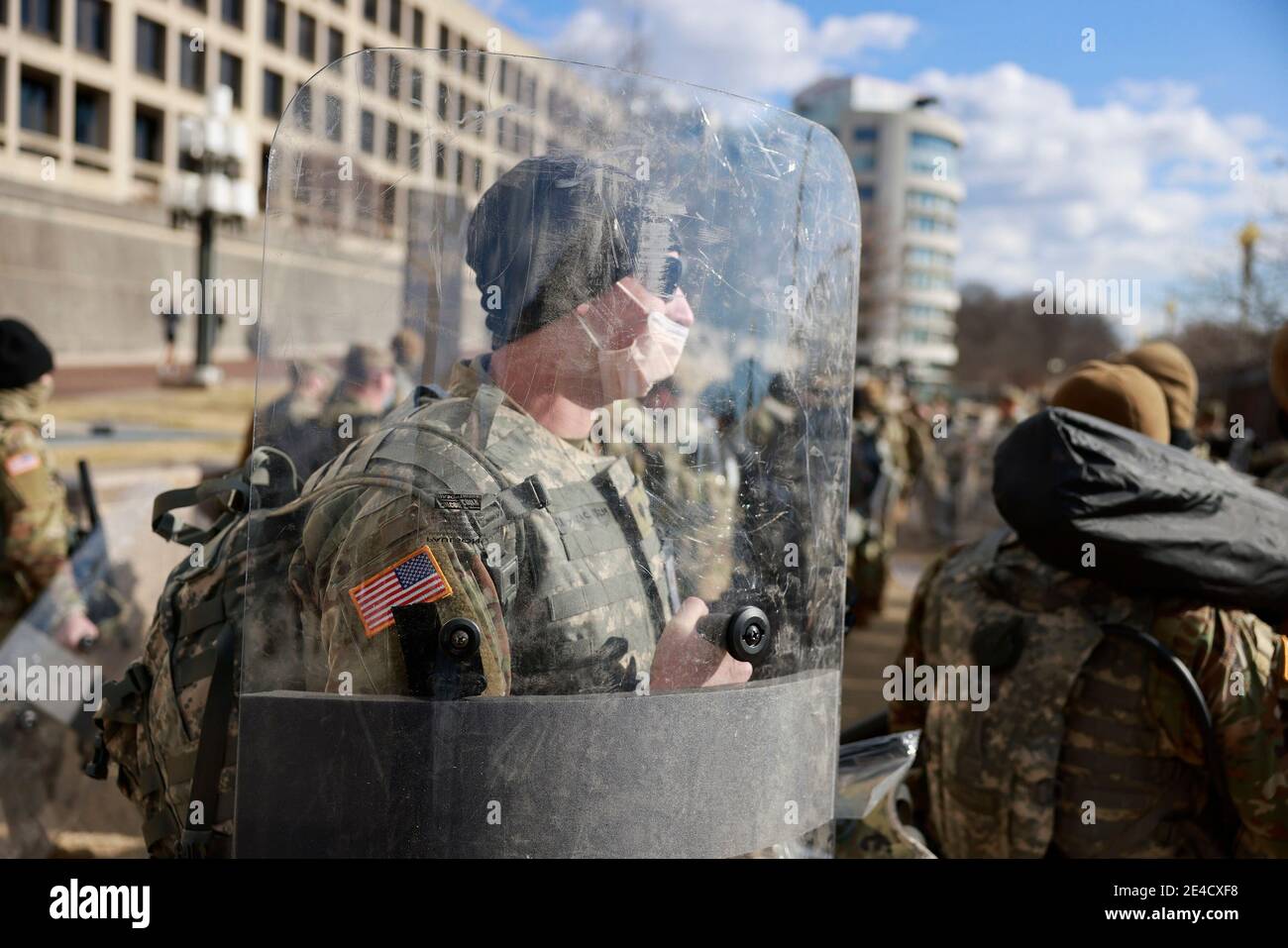 National Guard troops carry shields while repositioning at the United ...