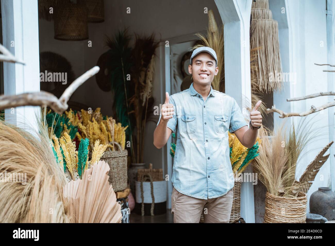 handicraft business owner with thumbs up in front of craft shop Stock ...