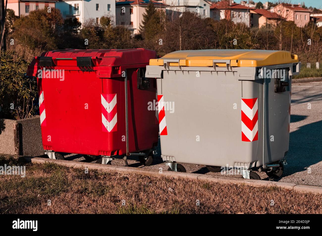 Colorful garbage bins at the side of a road (Pesaro, Italy, Europe