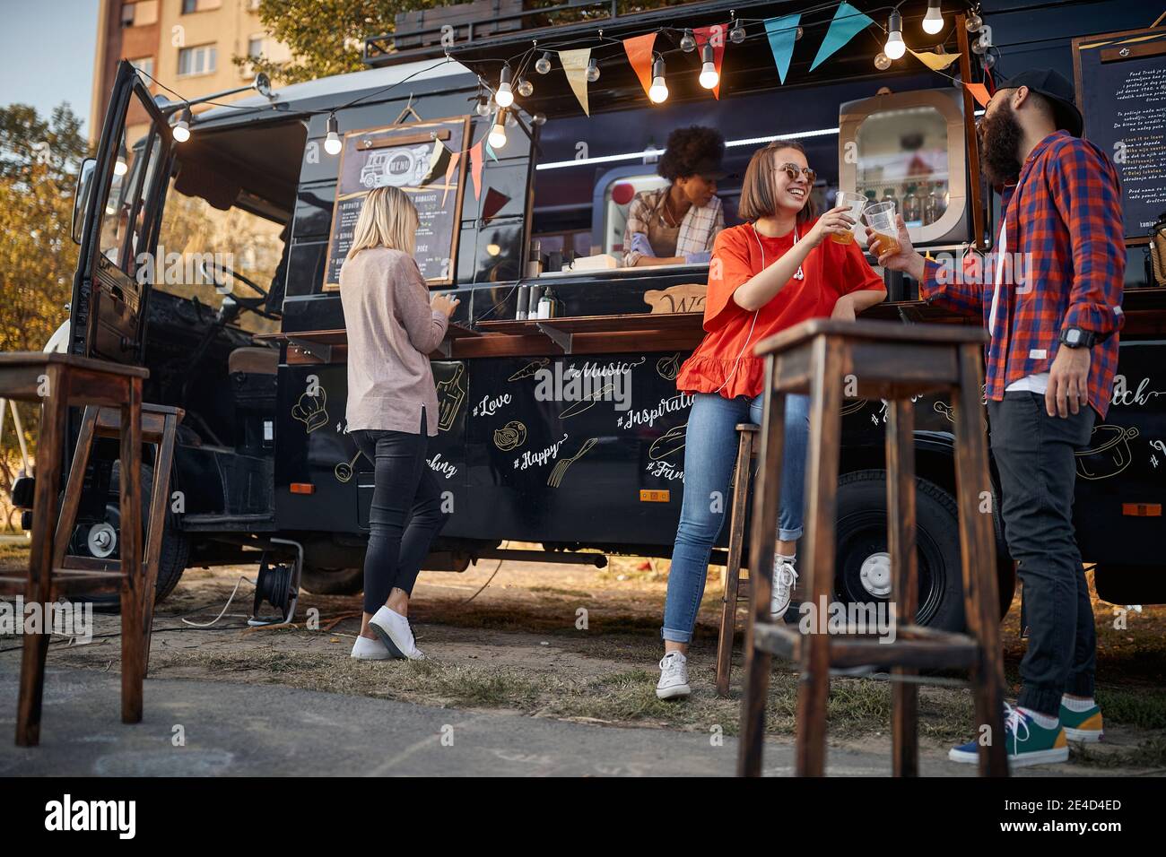 people enjoying in front of modified truck for mobile fast food service