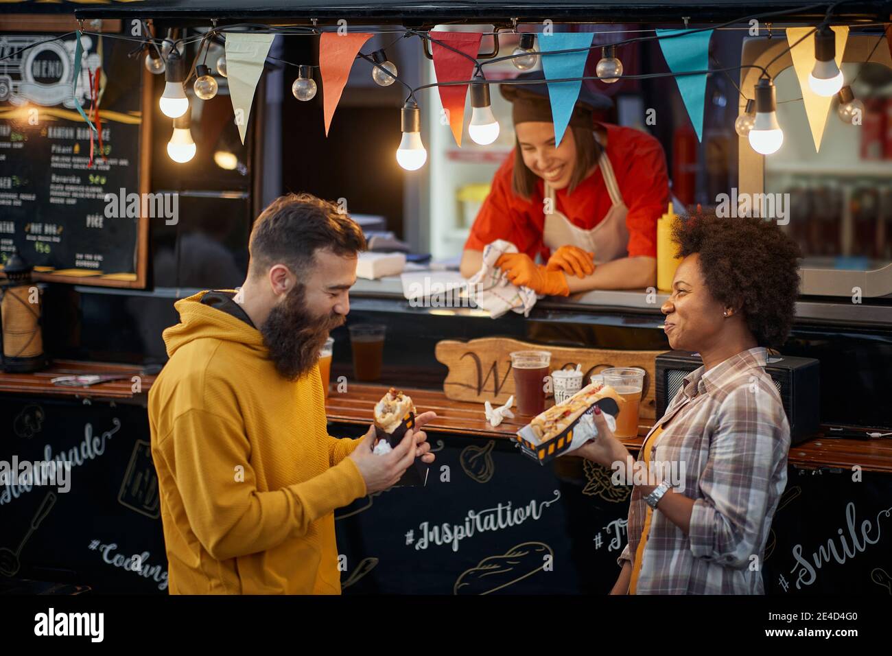 happy employee in fast food service smiling, looking multietchnic