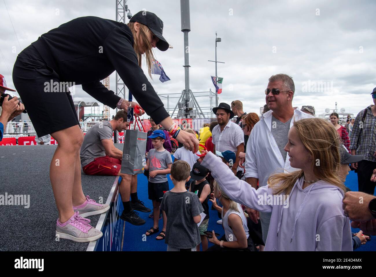Auckland, New Zealand. 23rd Jan, 2021. Young fans line up for rubber bracelets from Luna Rossa Prada Pirelli Team at the America's Cup village ahead of the Round Robin three match of the Prada Cup. Saturday 23th of Jan 2021. Copyright Credit: Chris Cameron/Alamy Live News Stock Photo
