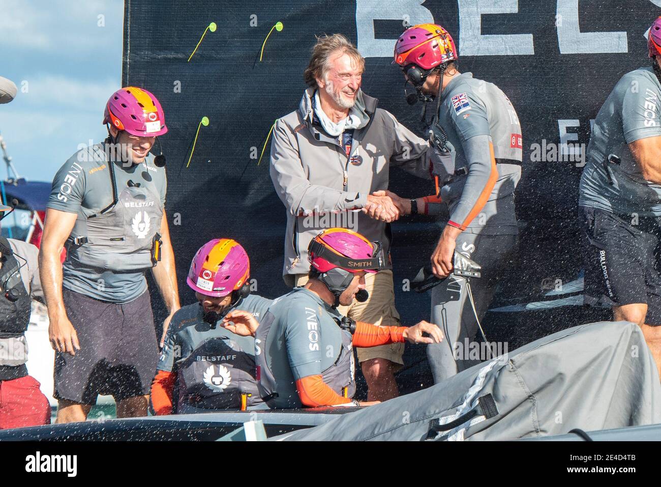 Auckland, New Zealand. 23rd Jan, 2021. INEOS Team UK celebrate on board Britania. Sir Jim Ratcliffe chairman and CEO of the Ineo shakes hands with Giles Scott after the team win the Round Robin section of the Prada Cup. Saturday 23th of Jan 2021. Copyright Credit: Chris Cameron/Alamy Live News Stock Photo