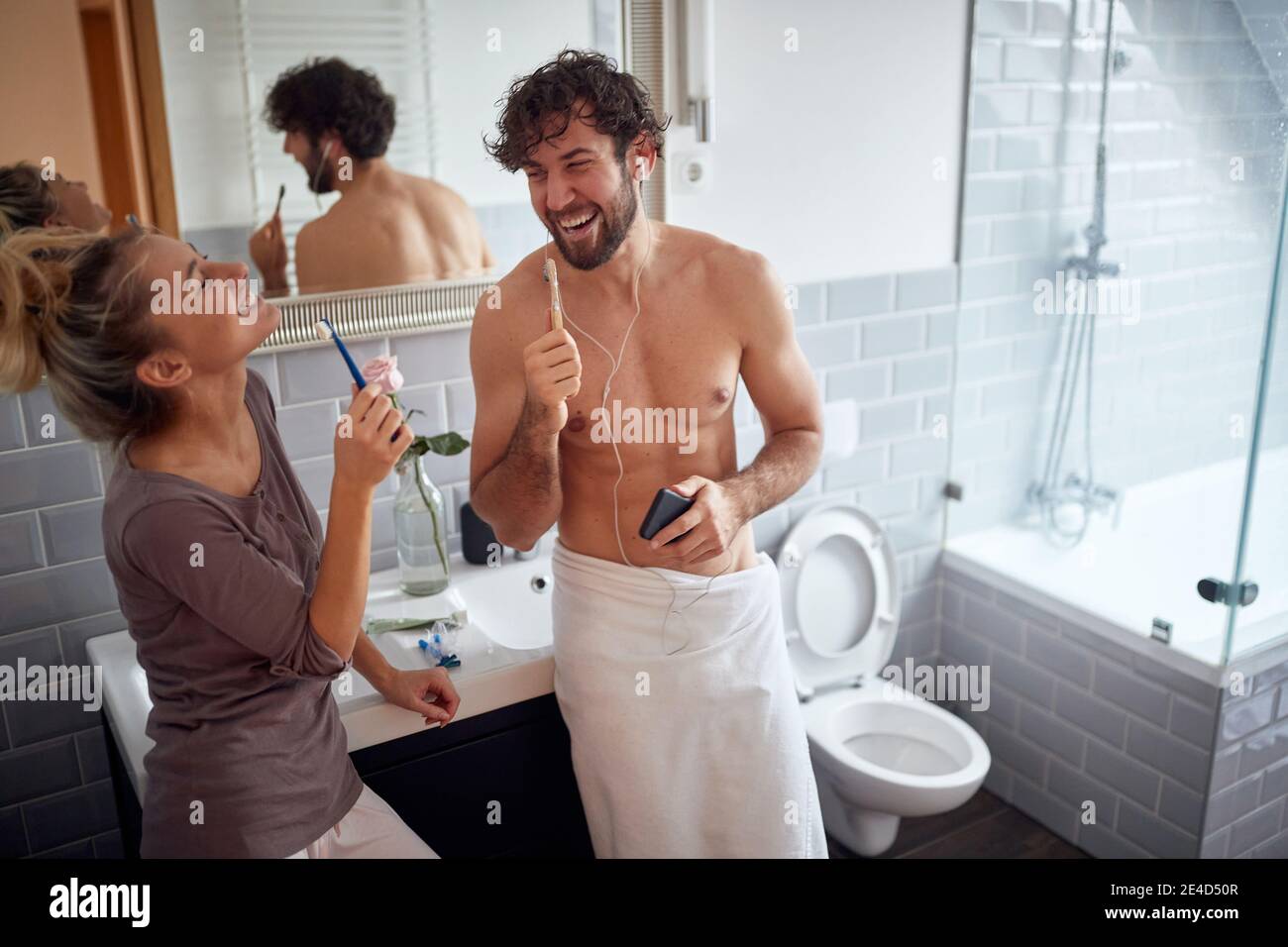 Adorable couple brushing teeth together in the morning Stock Photo