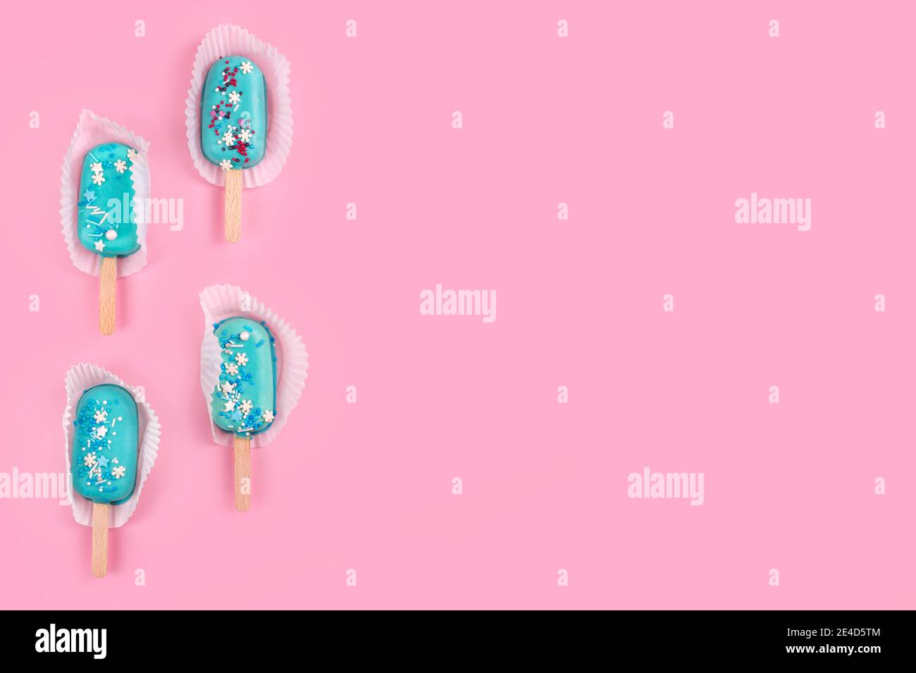 https://c8.alamy.com/comp/2E4D5TM/tasty-and-refreshing-ice-cream-on-sticks-blue-mint-ice-cream-popsicles-on-pastel-pink-background-minimal-summer-concept-flat-lay-2E4D5TM.jpg