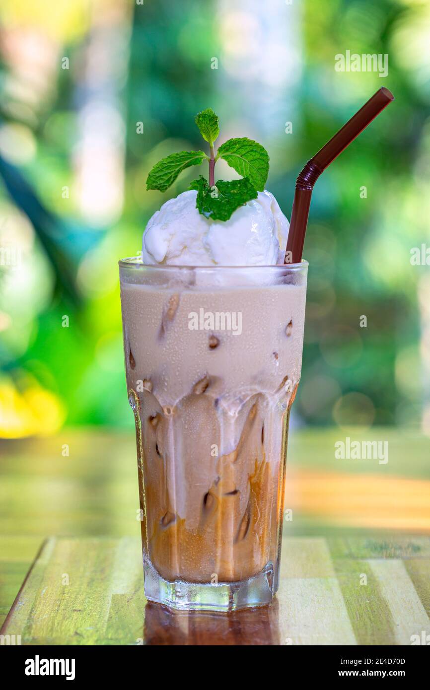 Glass of Thai Coffee smoothie topping with whip cream Stock Photo