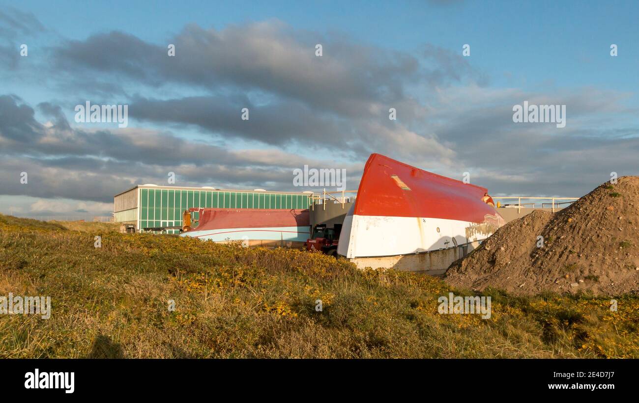 Thyboron, Denmark - 23 October 2020: Fishing cutters which are converted into a resturant, ship turned upside down and used for roofing, building rest Stock Photo