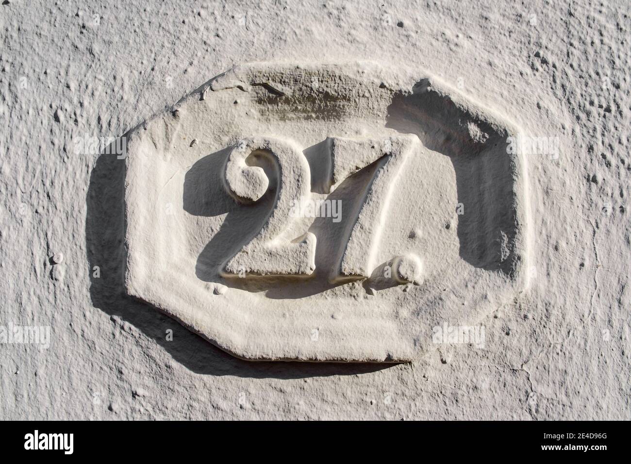 Number twenty seven on a white wall, typical white village of Mijas. Costa del Sol, Malaga province. Andalusia, southern Spain Europe Stock Photo