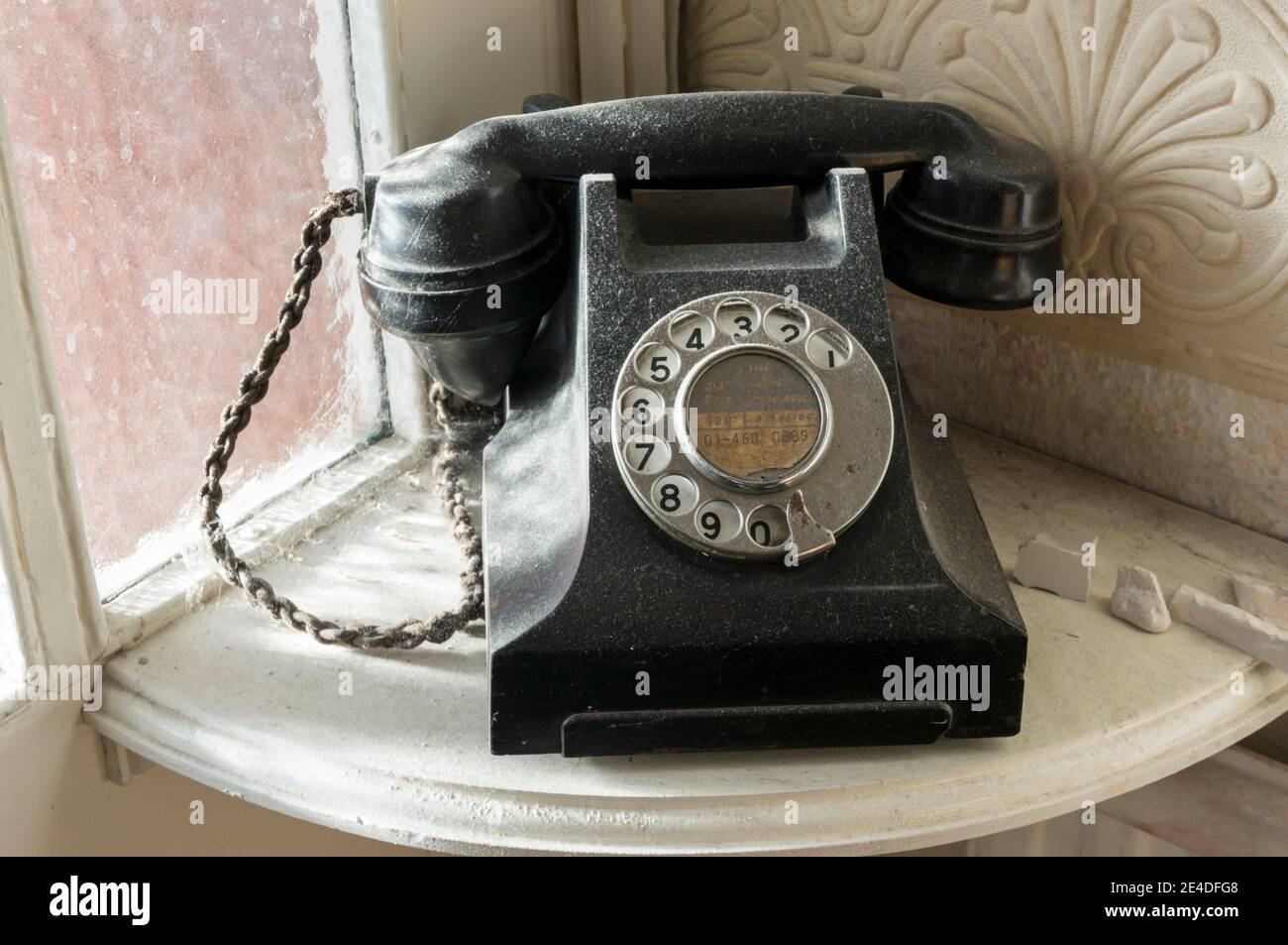A dusty old-fashioned abandoned 'phone in an old house. Stock Photo