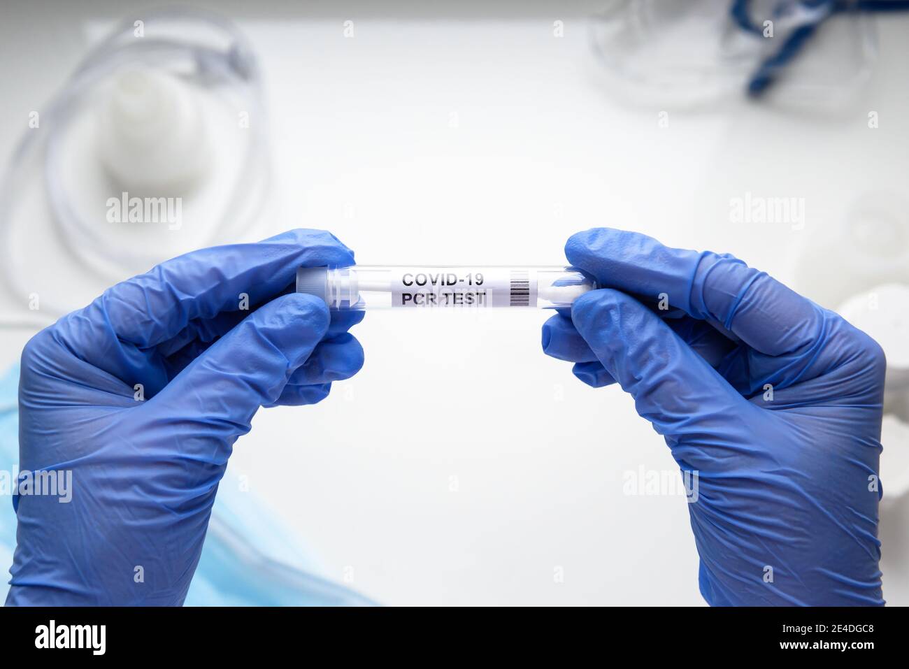 Coronavirus swab collection kit in doctor hands, tube of COVID-19 PCR test in laboratory on white background. Concept of corona virus diagnostics, med Stock Photo