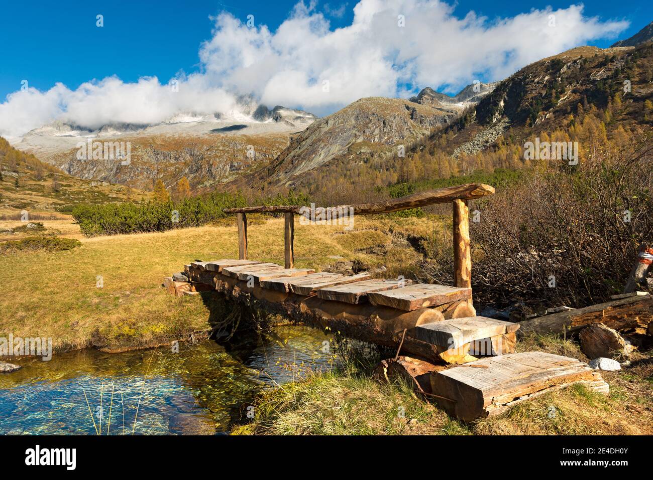Small wooden bridge of a trekking path in the National Park of Adamello Brenta, Val di Fumo. Trentino Alto Adige, Italy Stock Photo