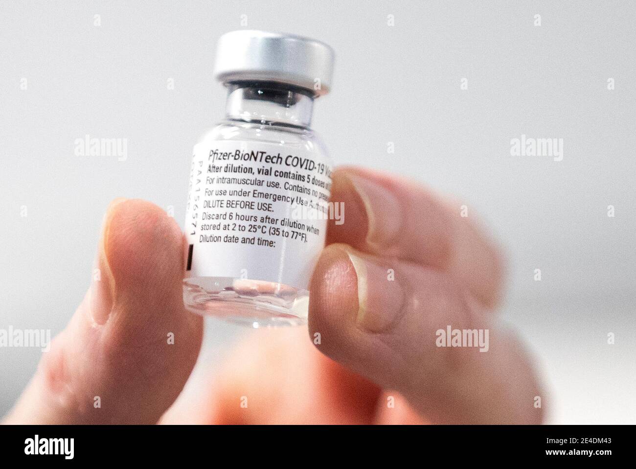 A nurse holds a bottle of Pfizer coronavirus vaccine at the NHS Louisa Jordan Hospital in Glasgow, as part of a mass vaccination drive by NHS Greater Glasgow and Clyde. Picture date: Saturday January 23, 2021. Stock Photo