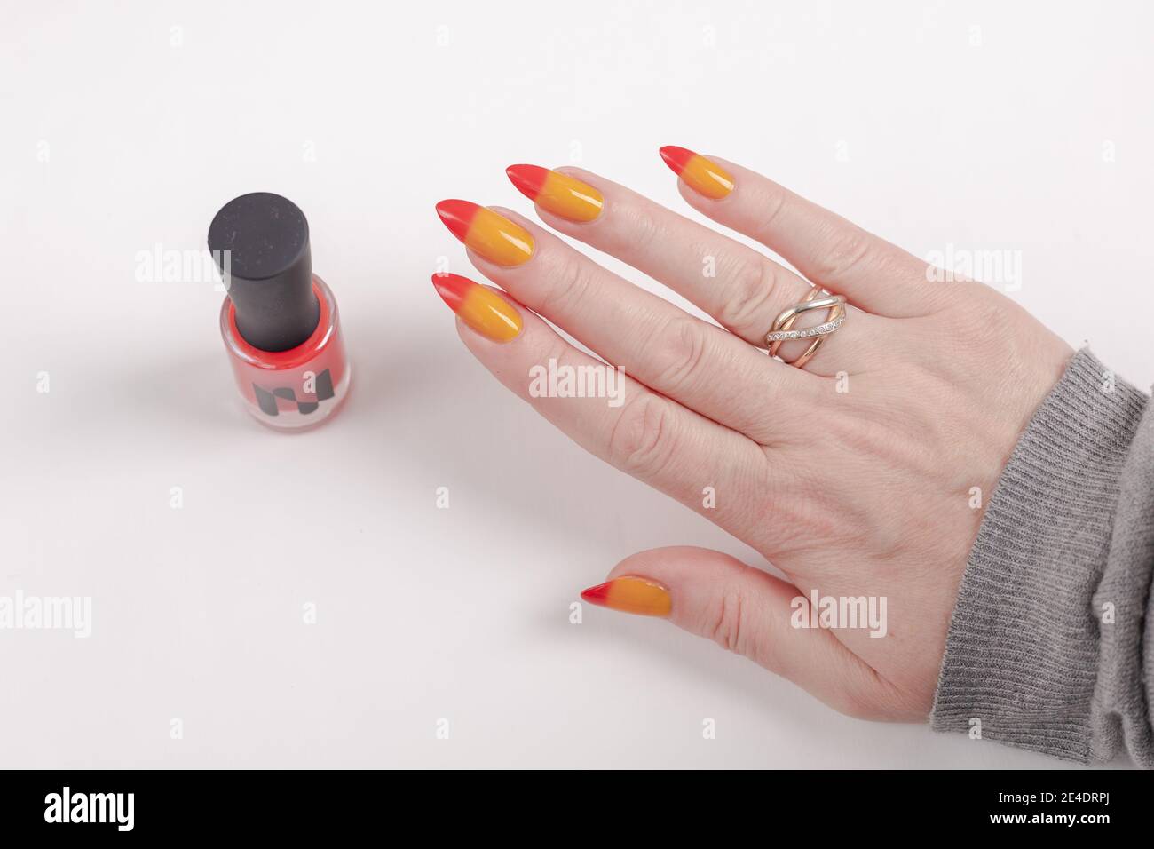 Female Hands With Long Nails With Yellow And Red Nail Polish Stock Photo Alamy