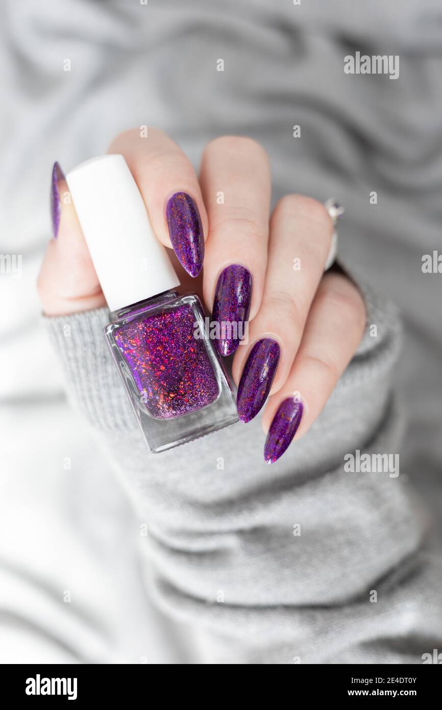 Womans Hands With Long Nails With Violet Purple Nail Polish Stock Photo Alamy