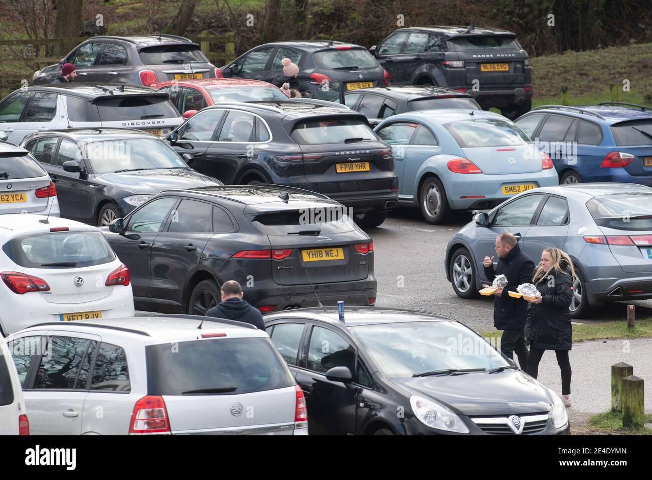 People walk through the car park at Bradgate Park in Leicestershire during England's third national lockdown to curb the spread of coronavirus. Picture date: Saturday January 23, 2021. Stock Photo