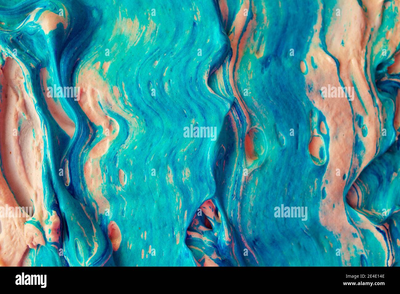 Artistic fluide abstract volume texture with blue color and orange tint. Rough strokes of paint. Thick heavy layer of flowing colored acrylic foam Stock Photo