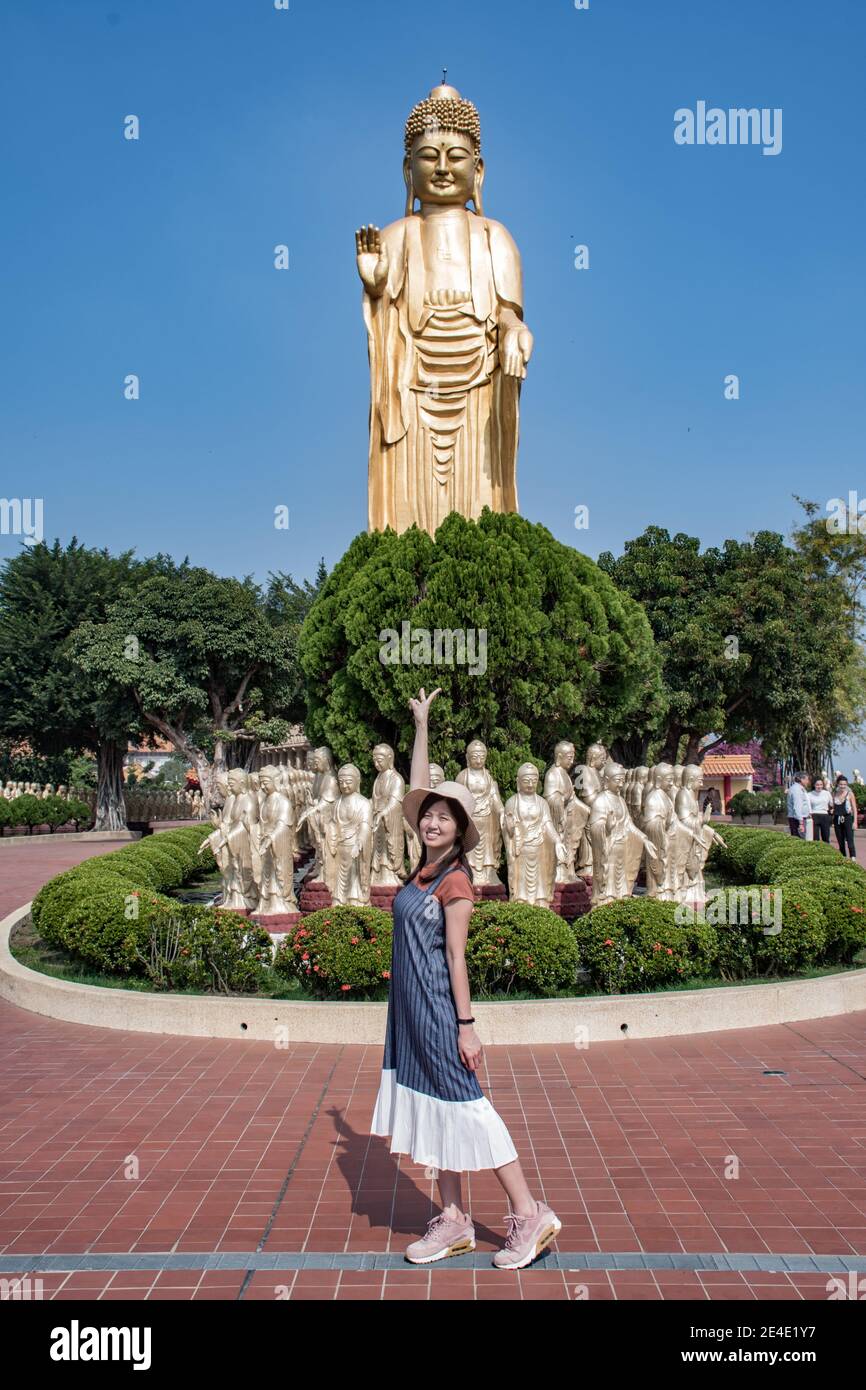 Prayer and the view of golden Buddha statue and giant Great Buddha