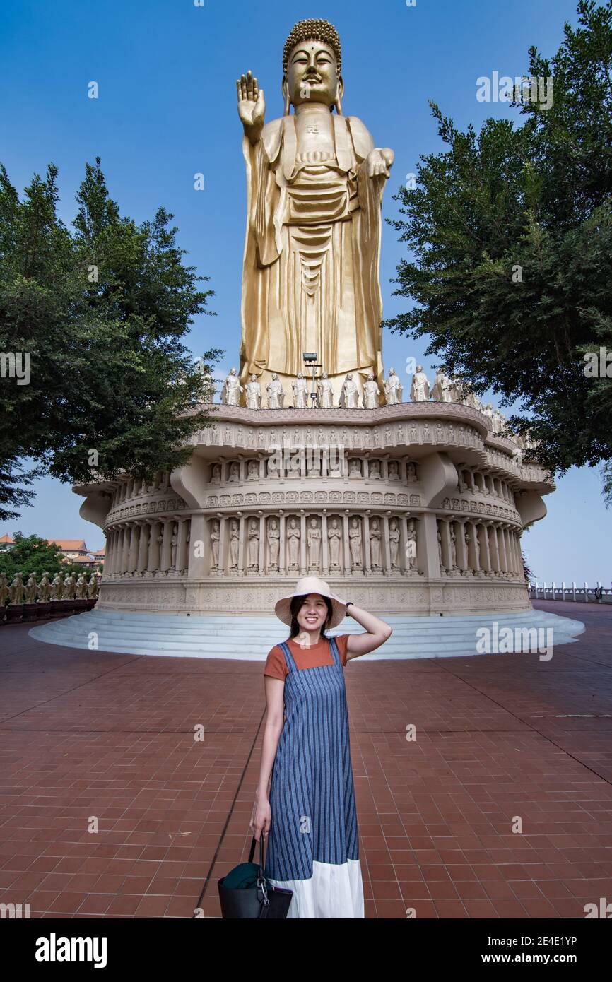 Prayer and the view of golden Buddha statue and giant Great Buddha