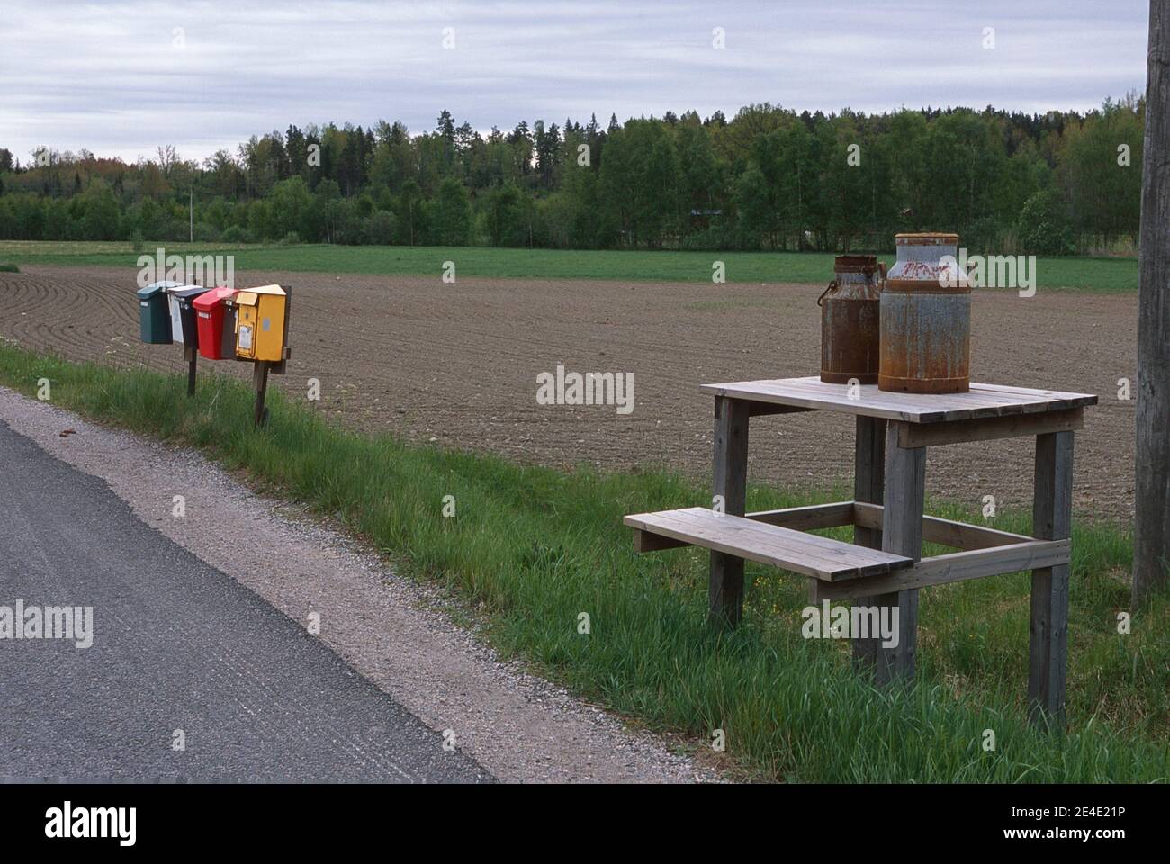 Country road with mailboxes and a milk pallet. Stock Photo