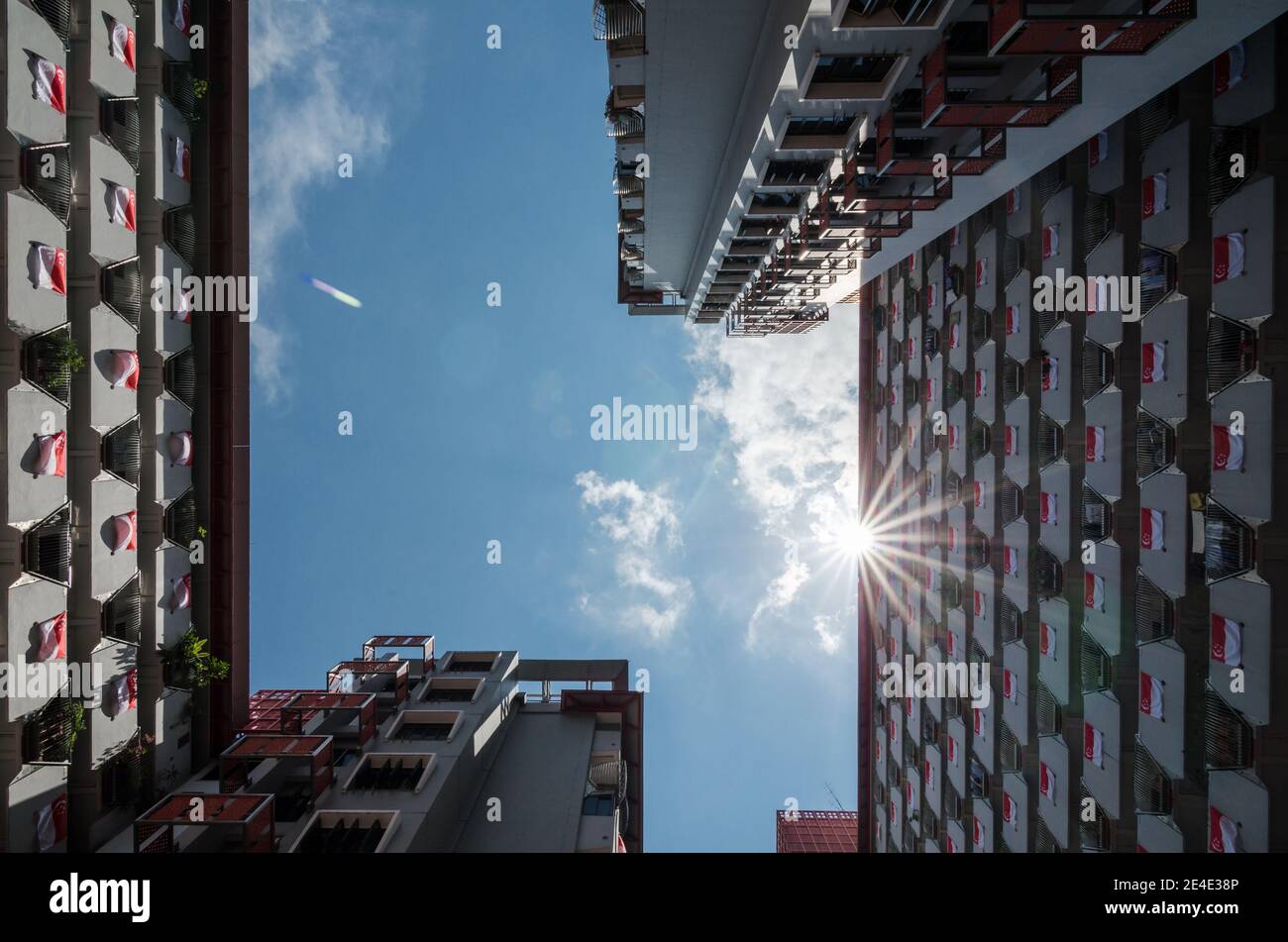 National flag of Singapore at HDB in Singapore to celebrate the National Day. The National Day of Singapore is celebrated every year on August 9. Stock Photo