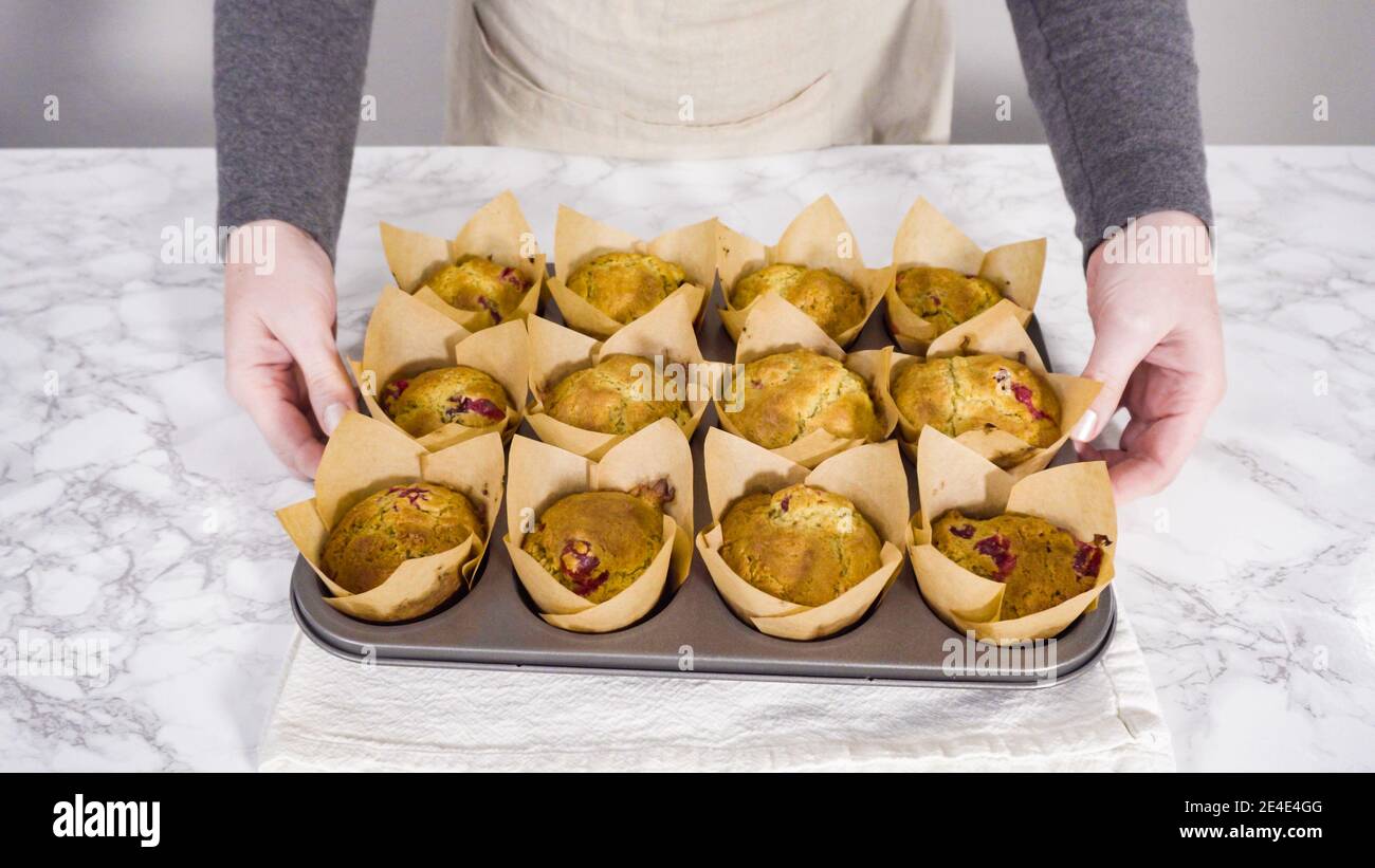 Step by step. Cooling freshly baked cranberry muffins. Stock Photo