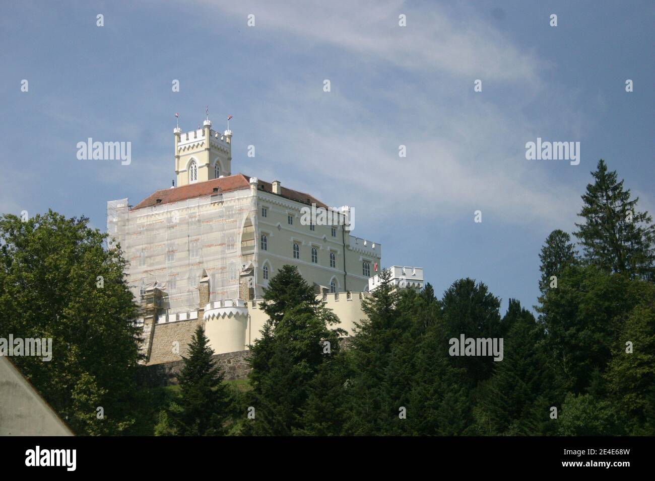 Trakošćan castle - a 13th century burg on a hill, surrounded by pine trees Stock Photo