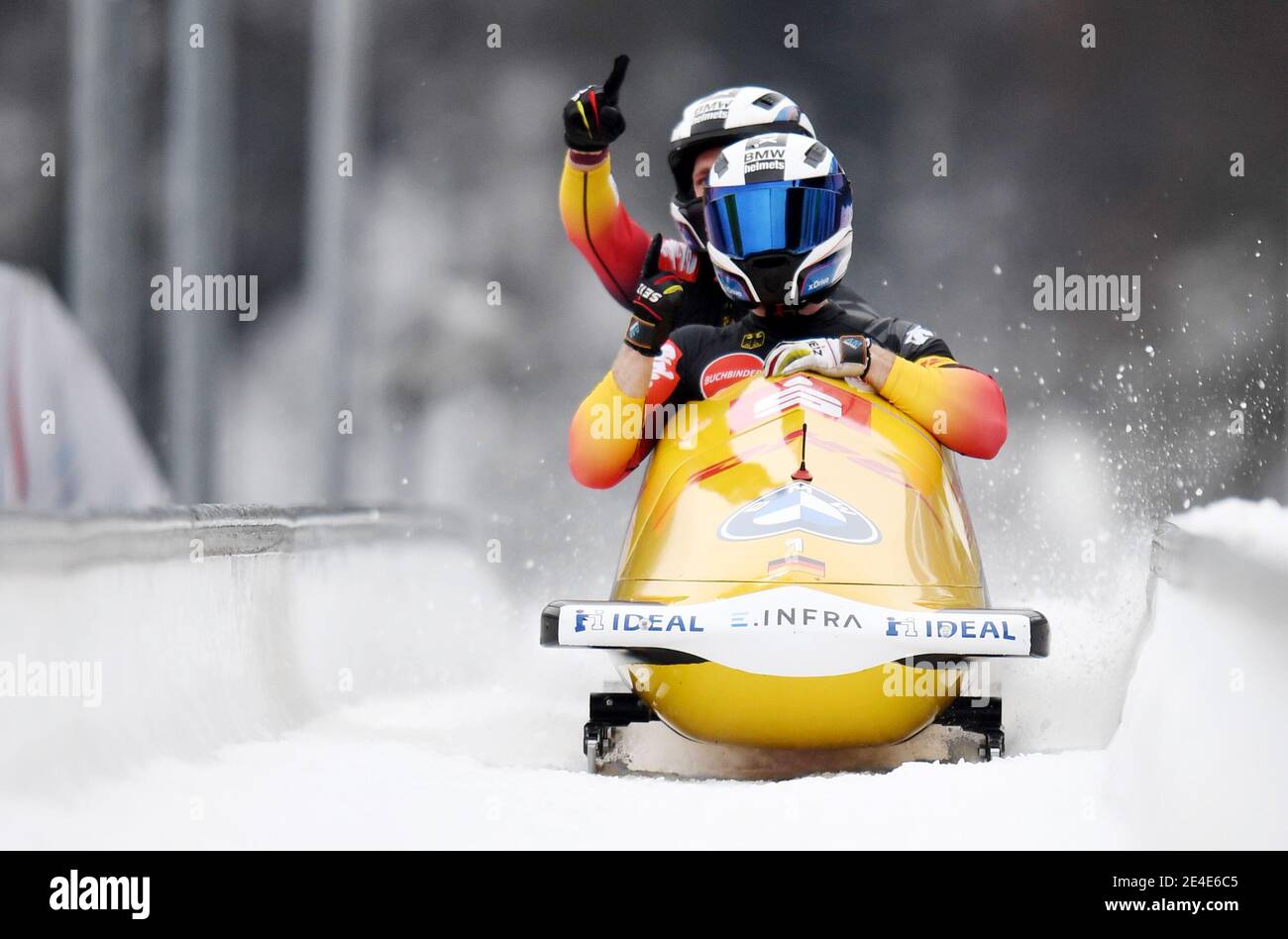 23 January 2021, Bavaria, Schönau Am Königssee: Bobsleigh: World Cup, two-man bobsleigh, men. German bobsledders Francesco Friedrich and Thorsten Margis cross the finish line jubilantly on the artificial ice track at Königssee. Friedrich and Margis took first place. Photo: Tobias Hase/dpa Stock Photo